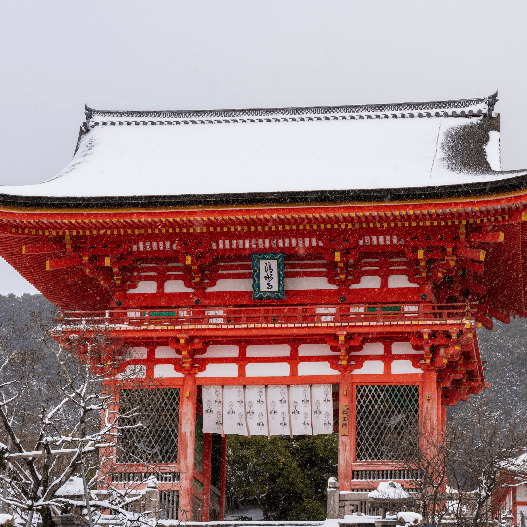 Peaceful snow-covered Japanese garden with traditional architecture in Kyoto during winter